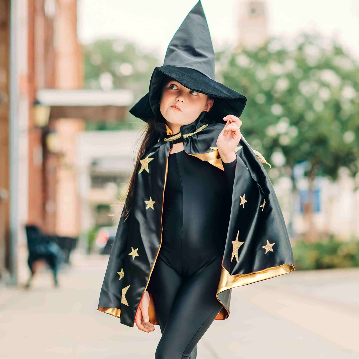 a little girl dressed up as a witch