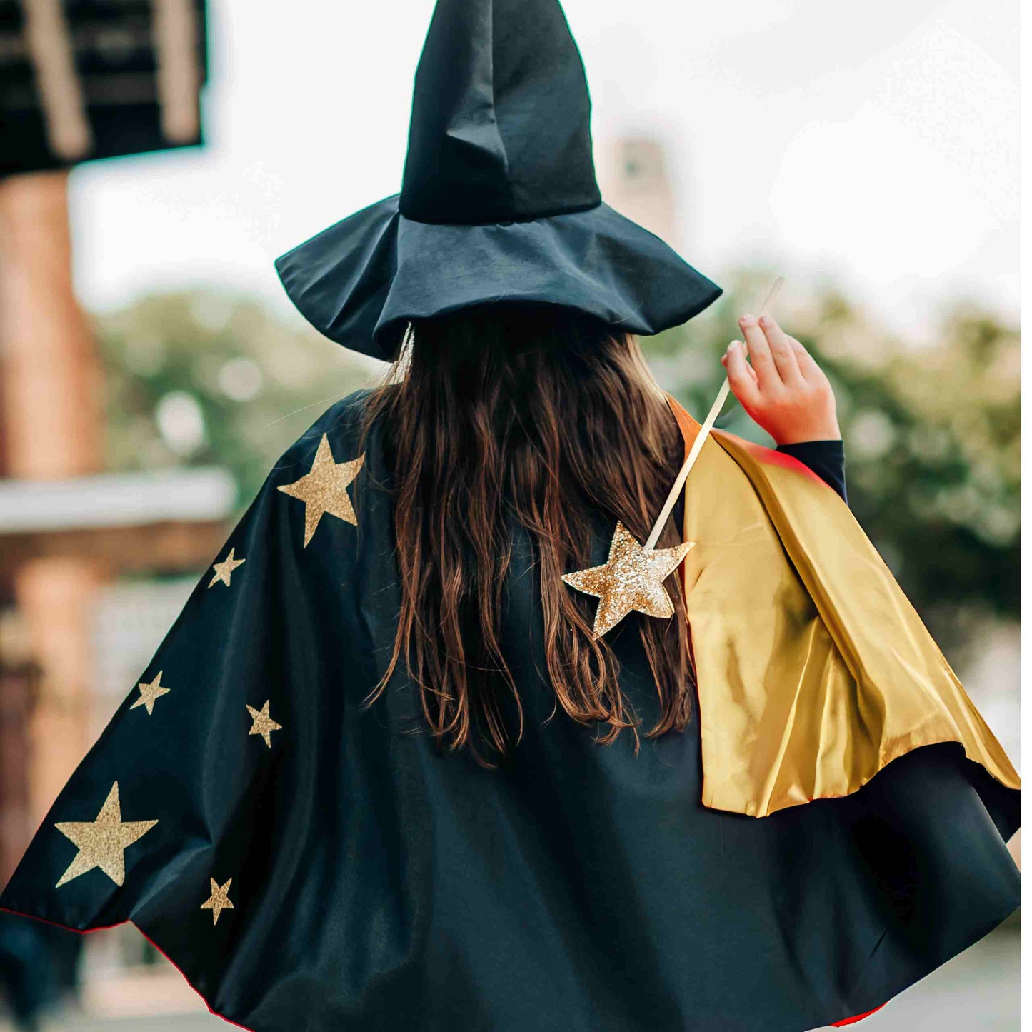 a woman in a witches costume holding a bag