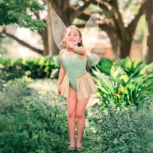 a little girl dressed in a fairy costume