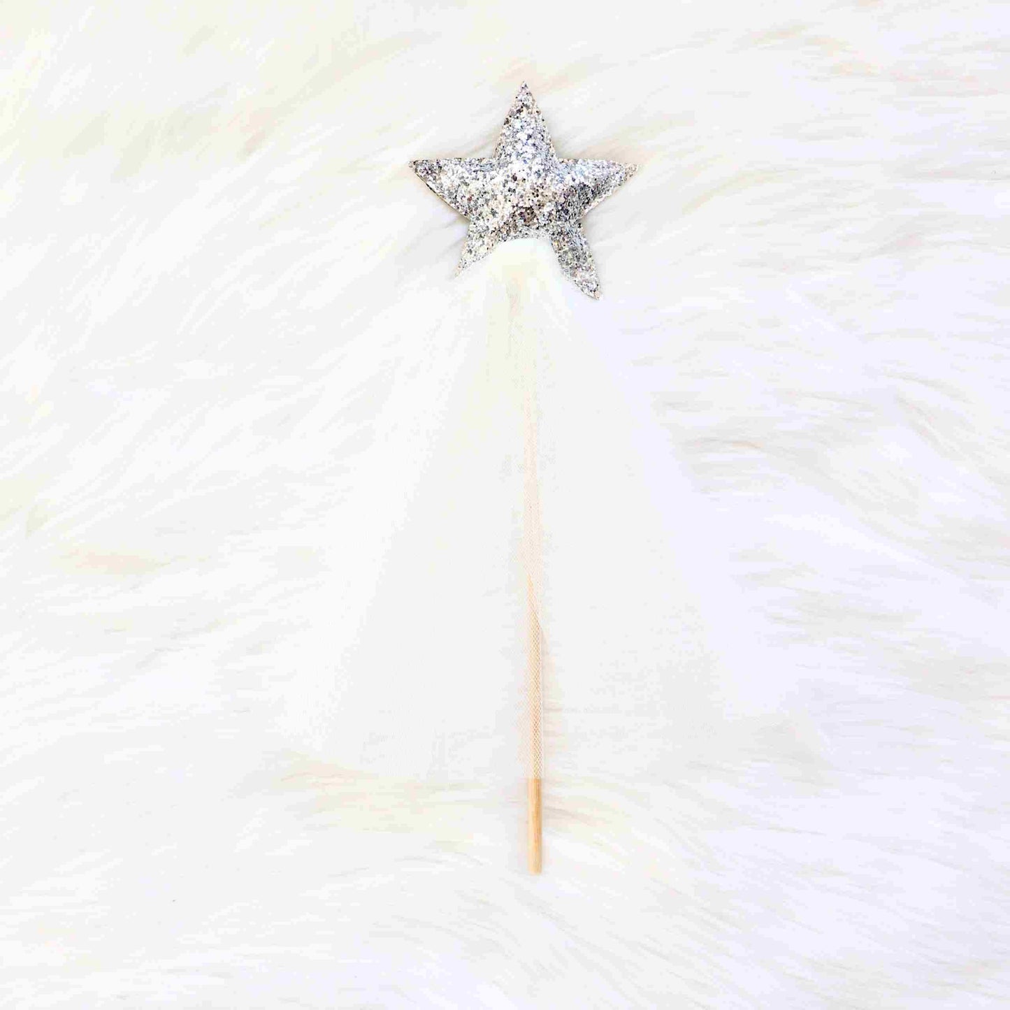 a star shaped object on a white fur surface